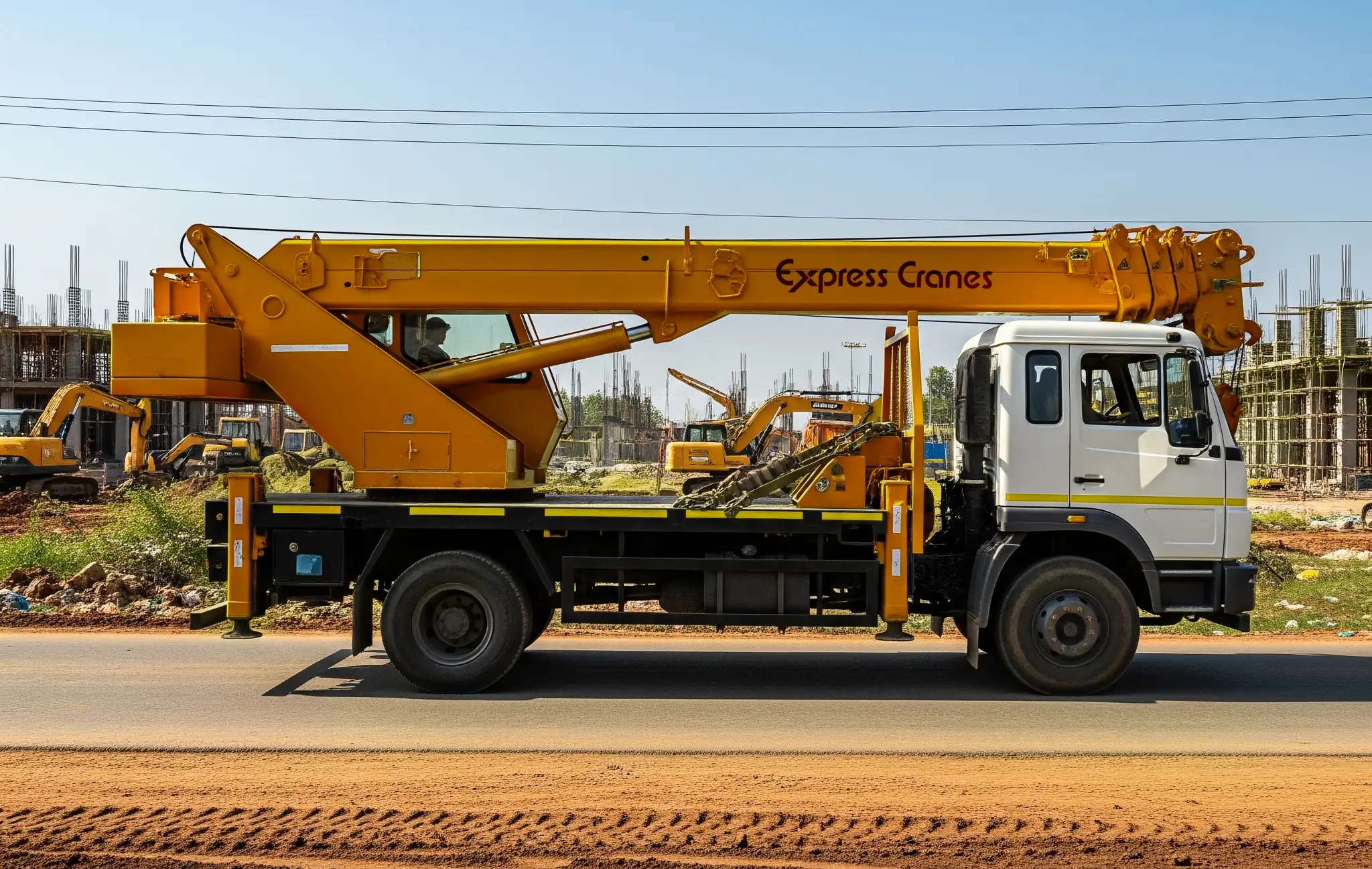 Truck-mounted telescopic boom crane driving to project